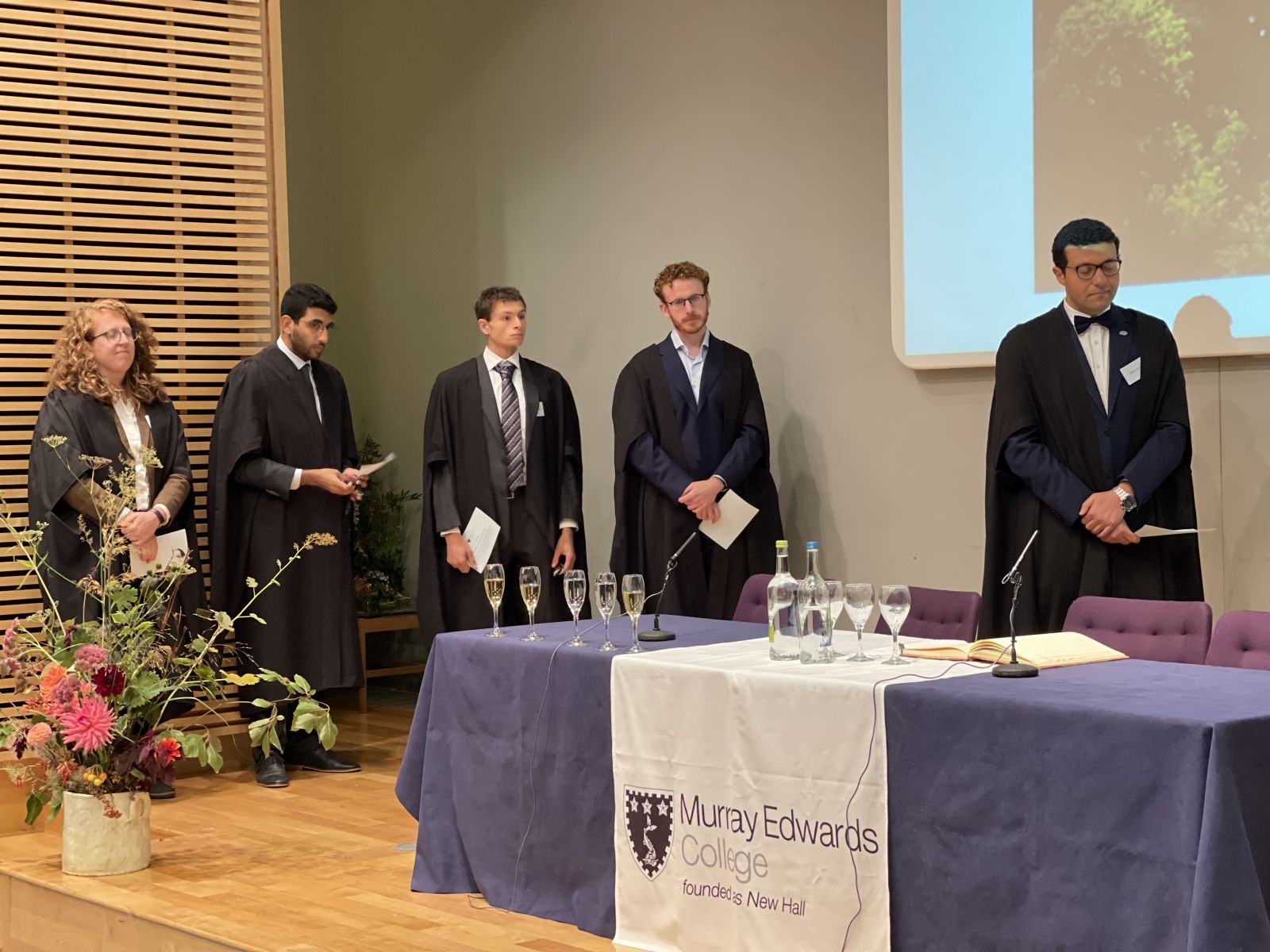 Five Fellows in a line on a stage. Left to right: Dr Joeva Rock, Dr Mohamed Moussa, Dr David Willer, Dr Tiarnan Doherty, and Dr Moataz Assem.