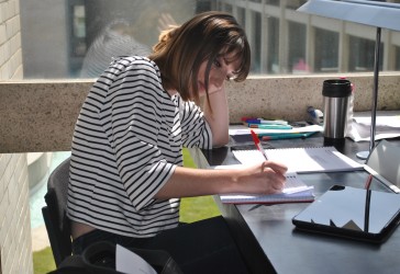 Picture showing a student working within the library overlooking Fountain Court